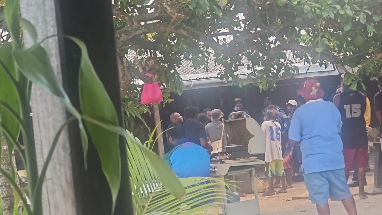 A community gathering under the trees