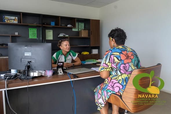 A Navara staff member meeting a member during the SPC Solar Home System evaluation